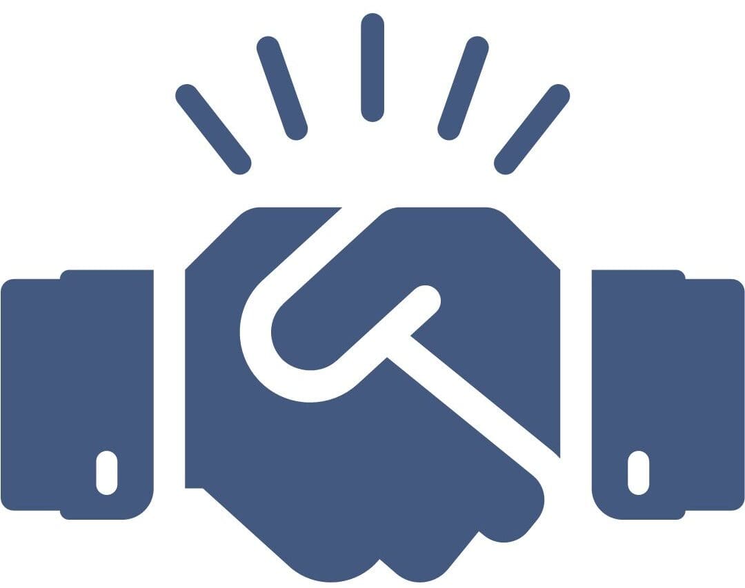 Two dentists shaking hands outside a dental practice building.