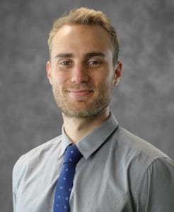 Professional headshot of a man in business attire.