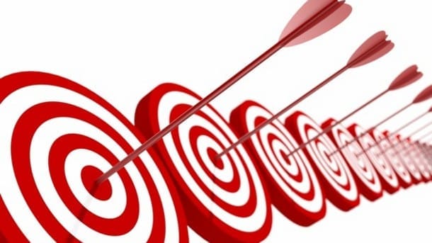 Several concentric circular archery targets with arrows embedded in the bullseyes.