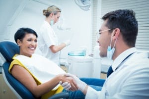Dentist presenting treatment plan to patient in dental office.