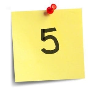Close-up of a yellow sticky note with the number '5' written on it, used for timing notifications.