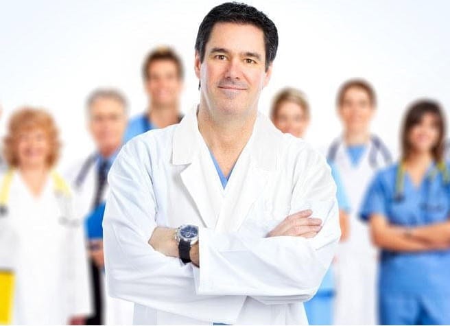 A dentist consulting with a patient in an office setting.