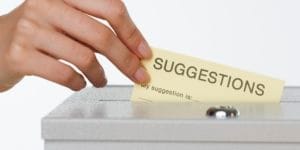 An office suggestion box with papers inside.
