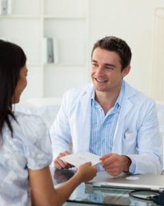 A patient admiring their corrected smile in a mirror.