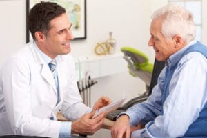 A patient making payment at the dental office front desk.
