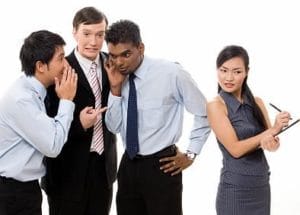 Image depicting workplace gossip among employees.