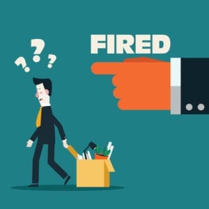 A manager discussing termination with an employee in an office setting.