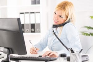 Friendly receptionist on phone.