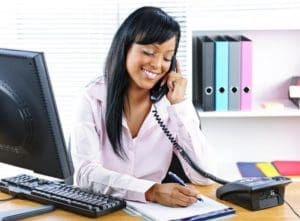 Dental office receptionist at front desk.