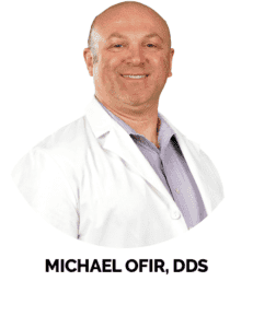 Circular portrait of Dr. Michael Ofir smiling in professional attire.