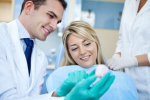 Dentist discussing treatment with a patient in a consultation room.