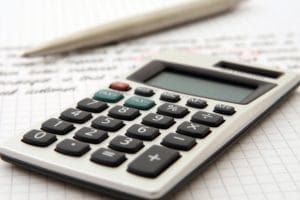 An accountant discussing financial reports with a client in an office.