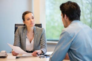 Dentist discussing financial arrangements with patient in office.