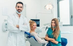 A patient reclining in a dental chair during a procedure.