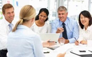 Dental staff team in a coordination meeting discussing goals.