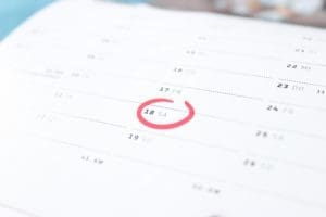 Close-up view of a desk calendar showing scheduled appointments and dates.
