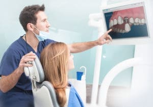 Computer screen displaying dental patient management software interface.