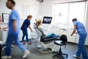 Portrait of a smiling female dentist in a modern dental office.