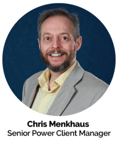 Professional headshot of a smiling man in business attire.