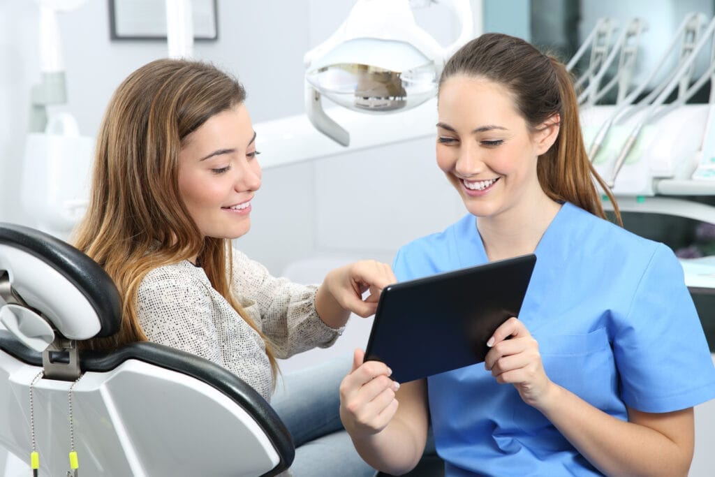 Dentist and patient choosing treatment together