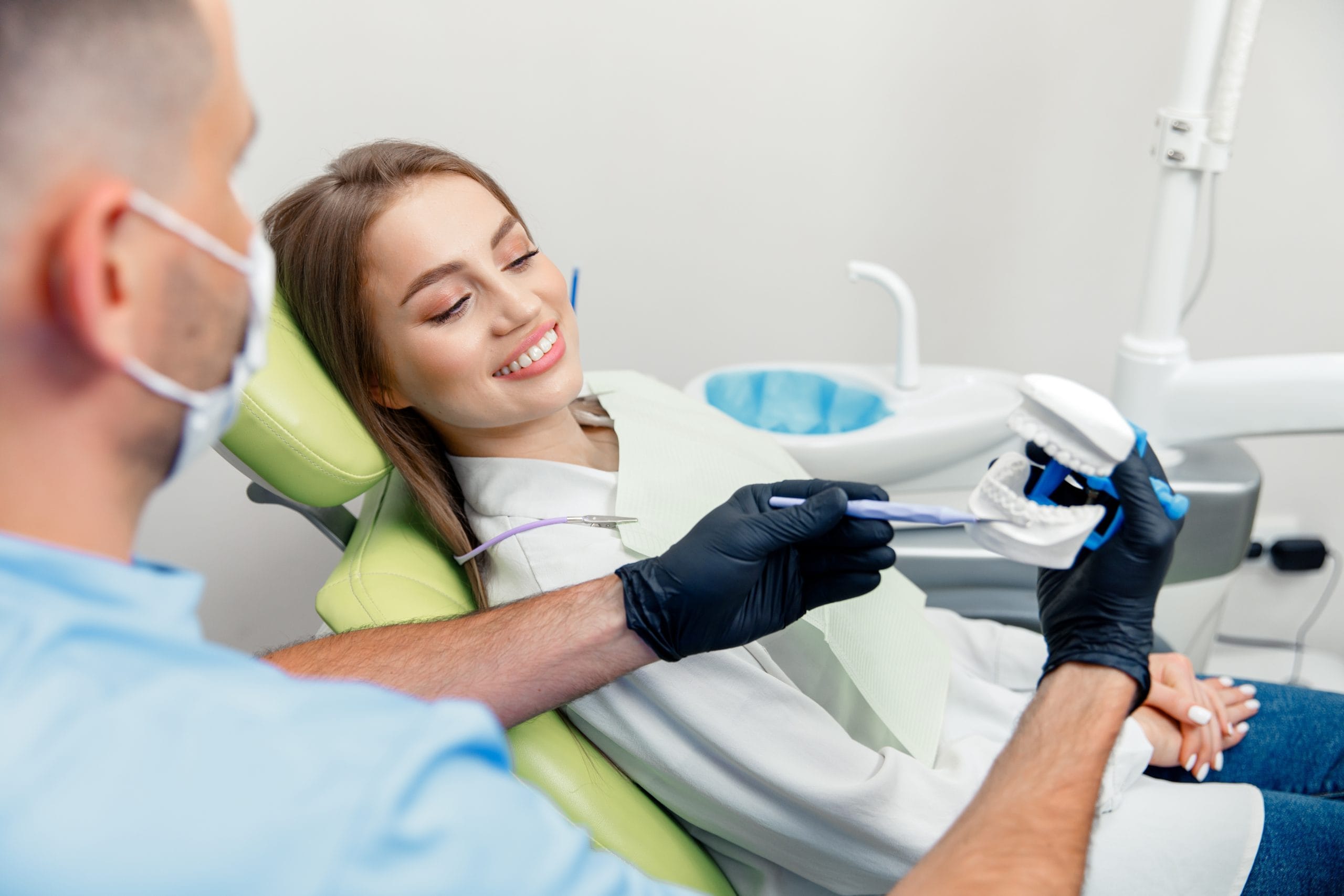 A smiling female patient in a medical examination room.