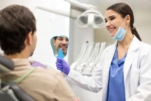 A smiling dental team standing together in a modern clinic, celebrating a successful day.
