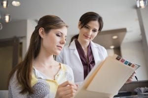Dental staff in a modern office setting, engaged in various tasks.