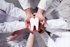 Group of healthcare professionals collaborating in a clinic environment.