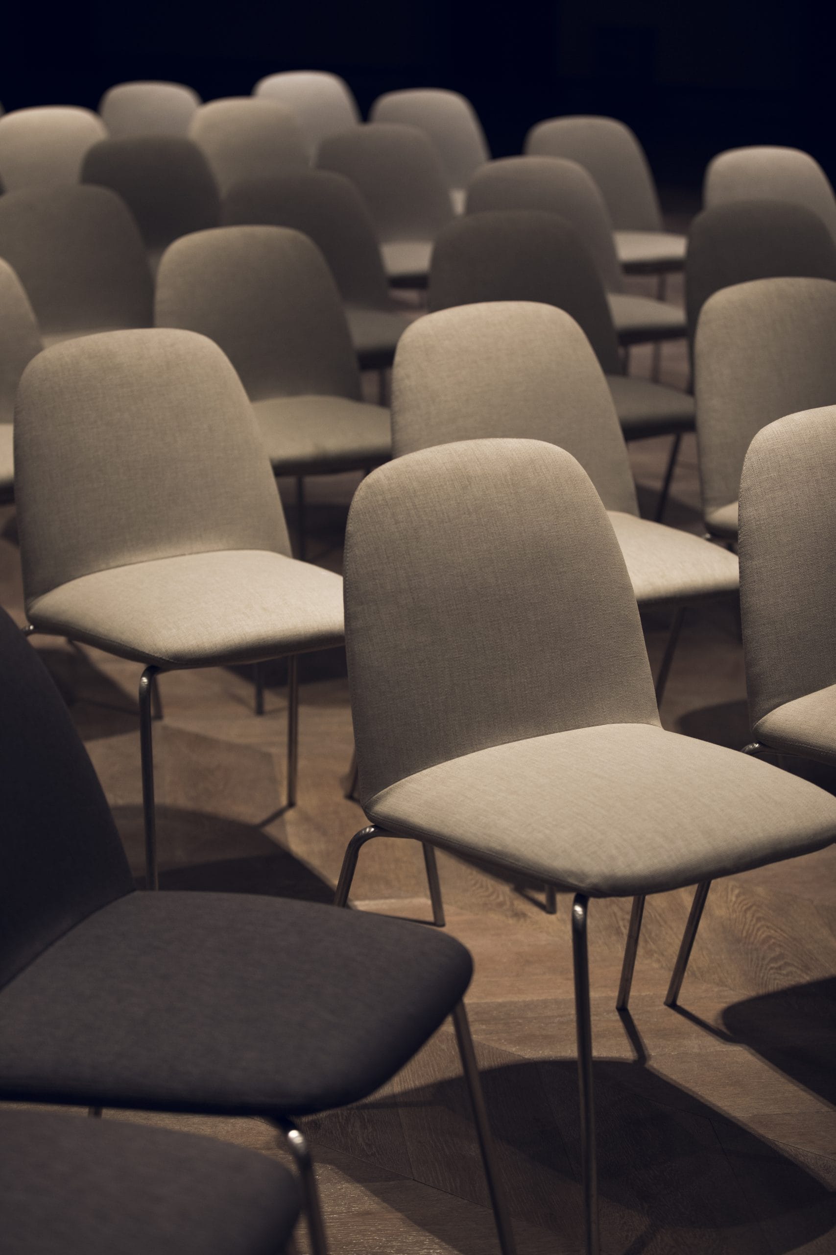 Arranged empty chairs in an indoor setting.
