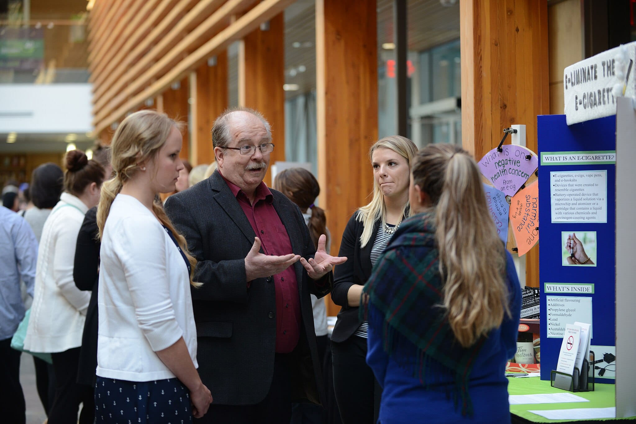 Attendees engaging with health information booths at a health fair.